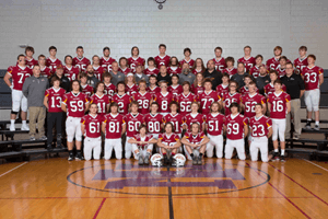 Coaches and football team posing for a photo