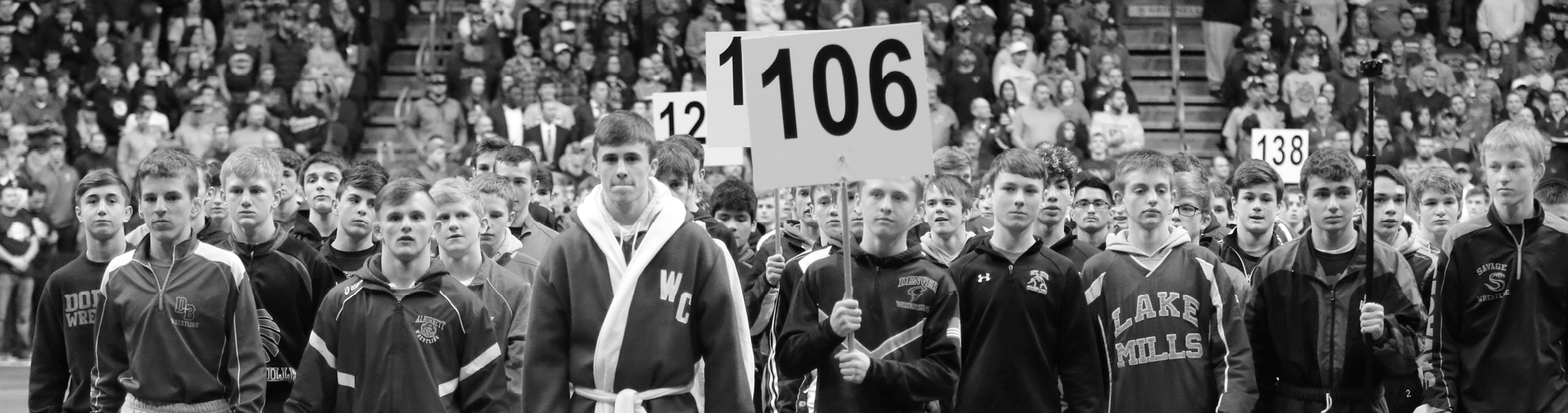 Wrestling players holding up numbered signs
