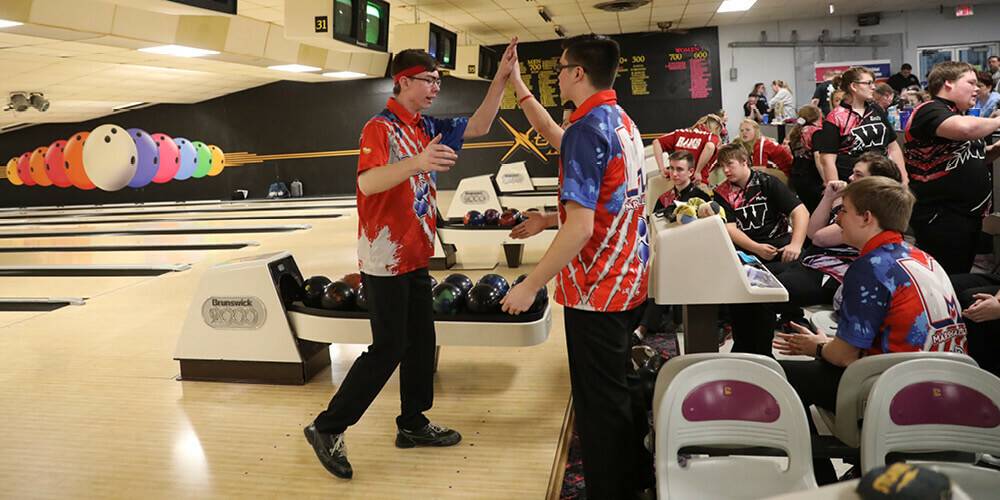 Celebrating with a high five during a bowling game