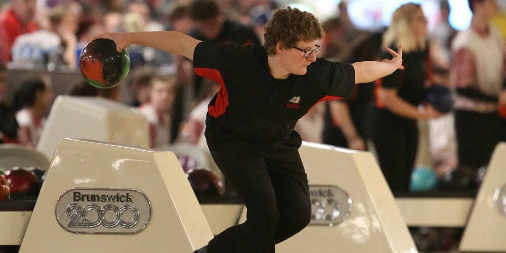 Action shot of a high school student during a bowling match