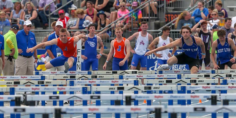 Running over hurdles during a track meet