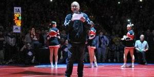 A man makes an announcement during a wrestling match