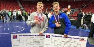 Two IHSAA Wrestlers pose for a photo with their medals