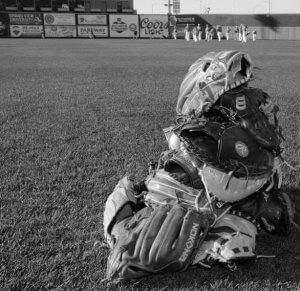 a pile of baseball mitts