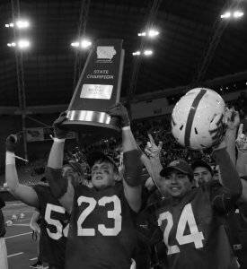 football players holding a state champion trophy