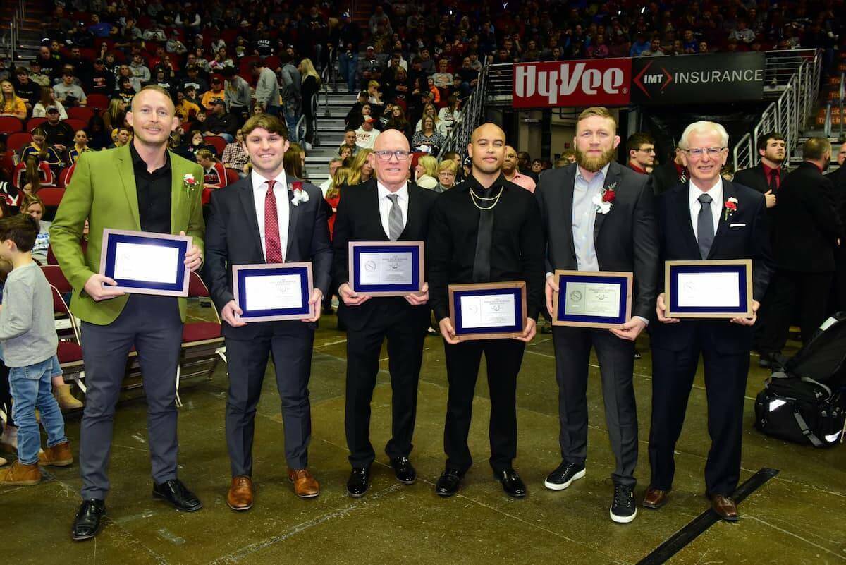 six men in suits accepting awards