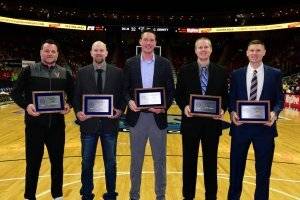an image of five men holding awards on a basketball court